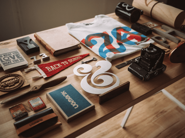 Branding materials on a table to depict how to create a consistent brand identity.
