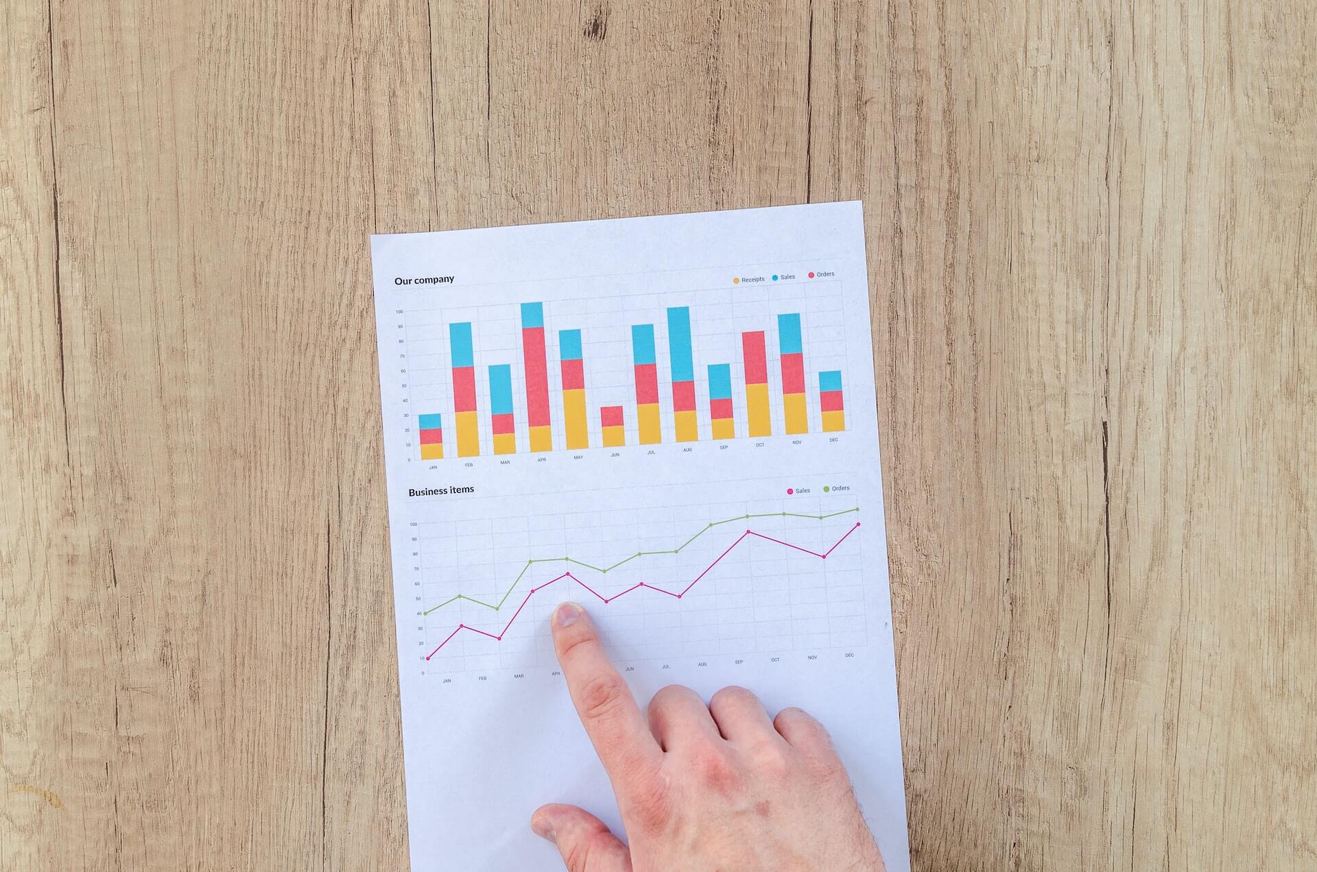 A piece of paper with infographics, on a wooden table.