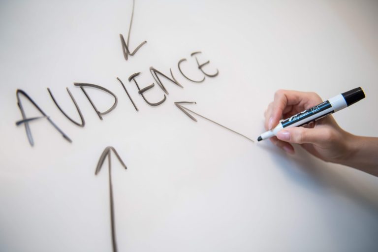 A white board with the word "audience" written in the middle and arrows pointing towards it.