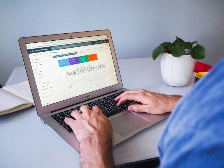 A person with their hands on a laptop's keyboard. The screen is opened to Google Search Console.