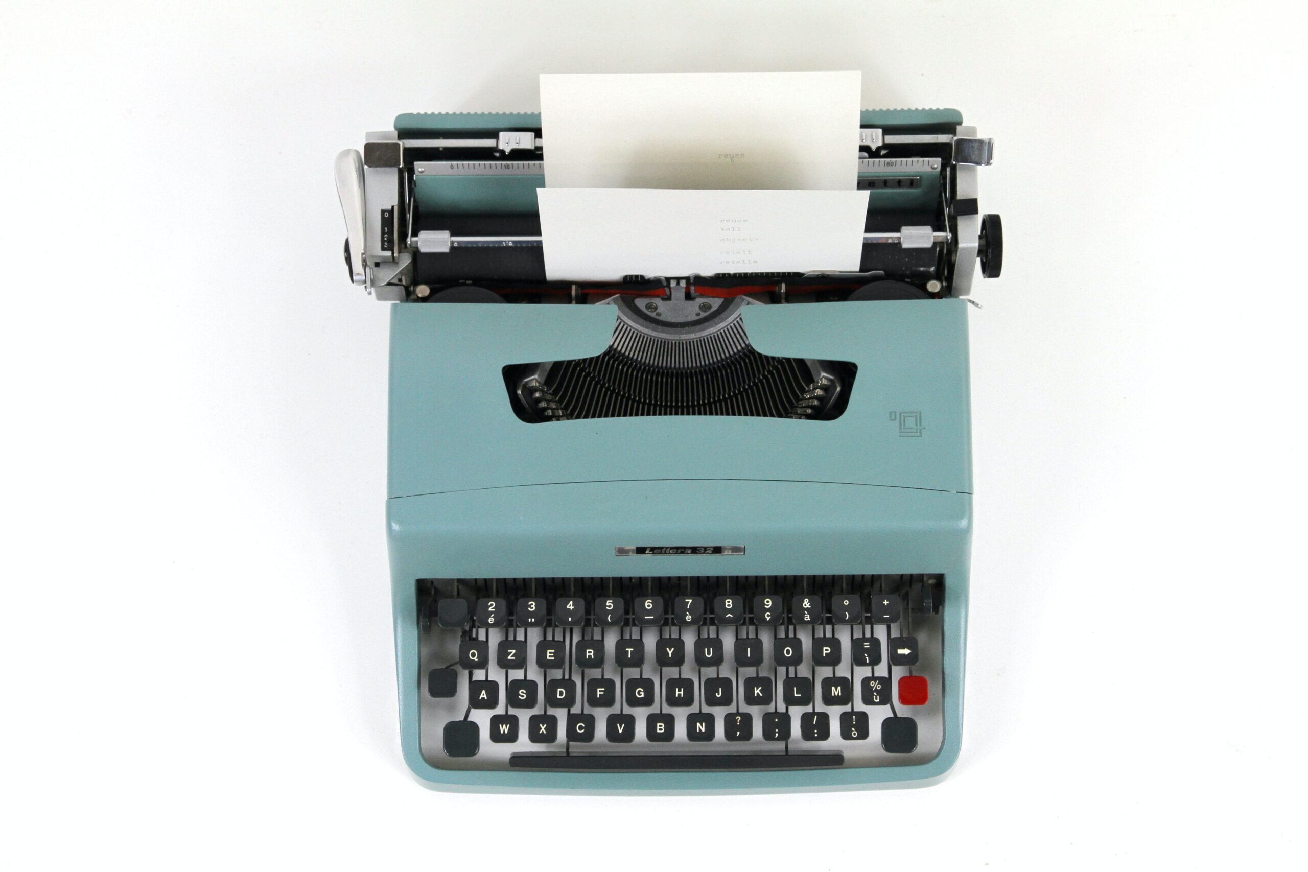 Light blue typewriter from a bird's eye view.